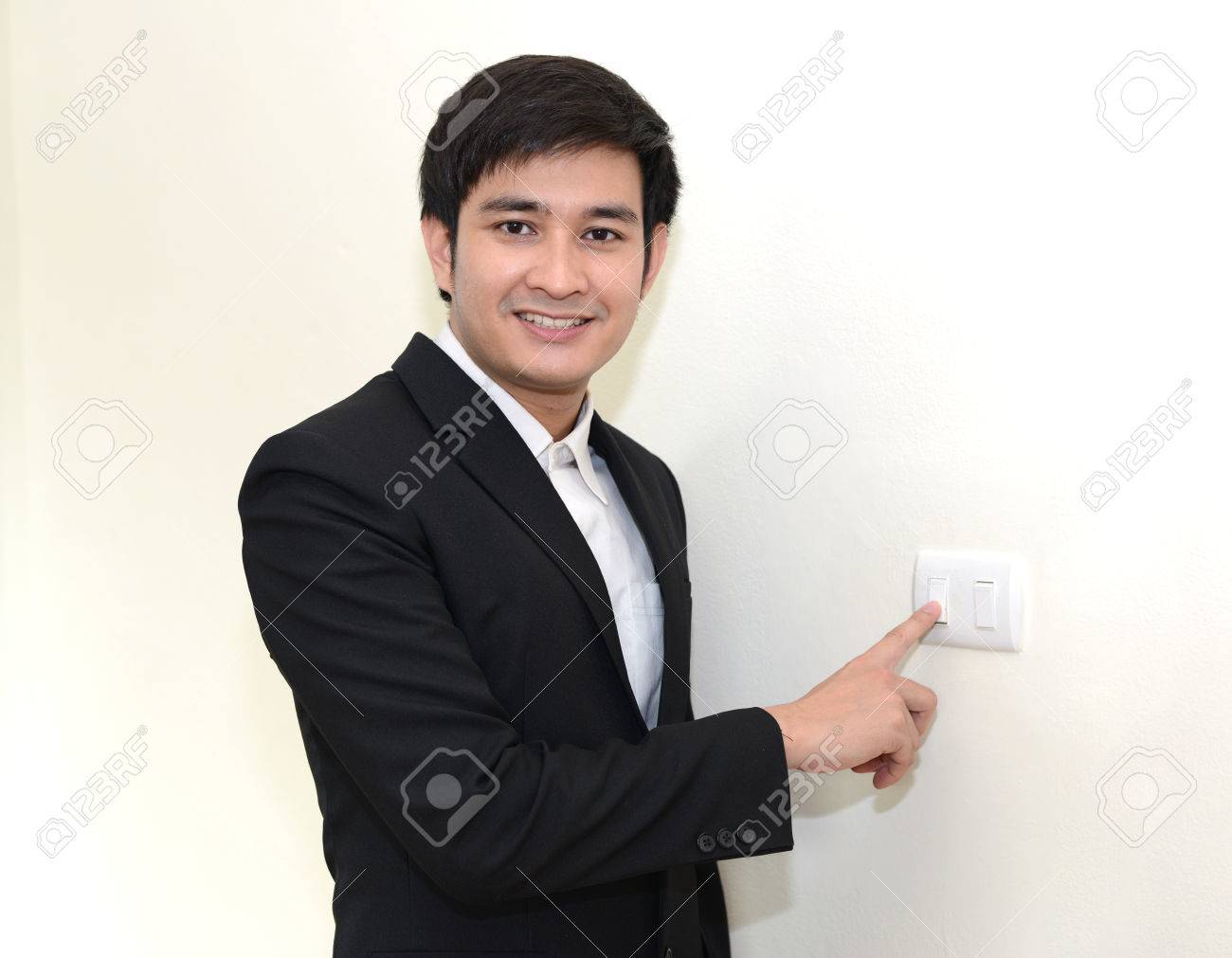 Asian Handsome Business Man Turning Off Or Turning On The Wall-mounted Light  Switch. Stock Photo, Picture and Royalty Free Image. Image 33202056., image size:1300x1011