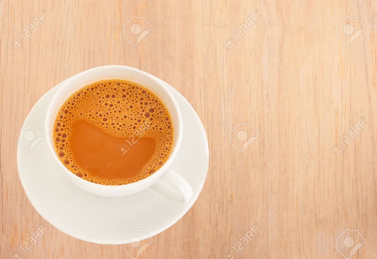 Hot Milk Tea In A White Cup On Wooden Background Stock Photo, Picture And  Royalty Free Image. Image 44985487.