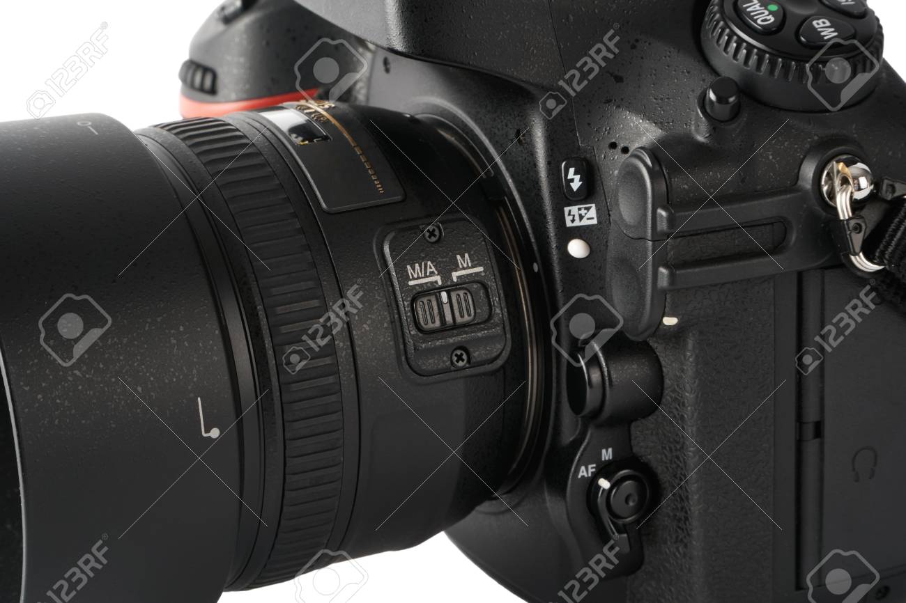 closeup of Auto focus and Manual focus switch on a dslr camera with lens.  Stock