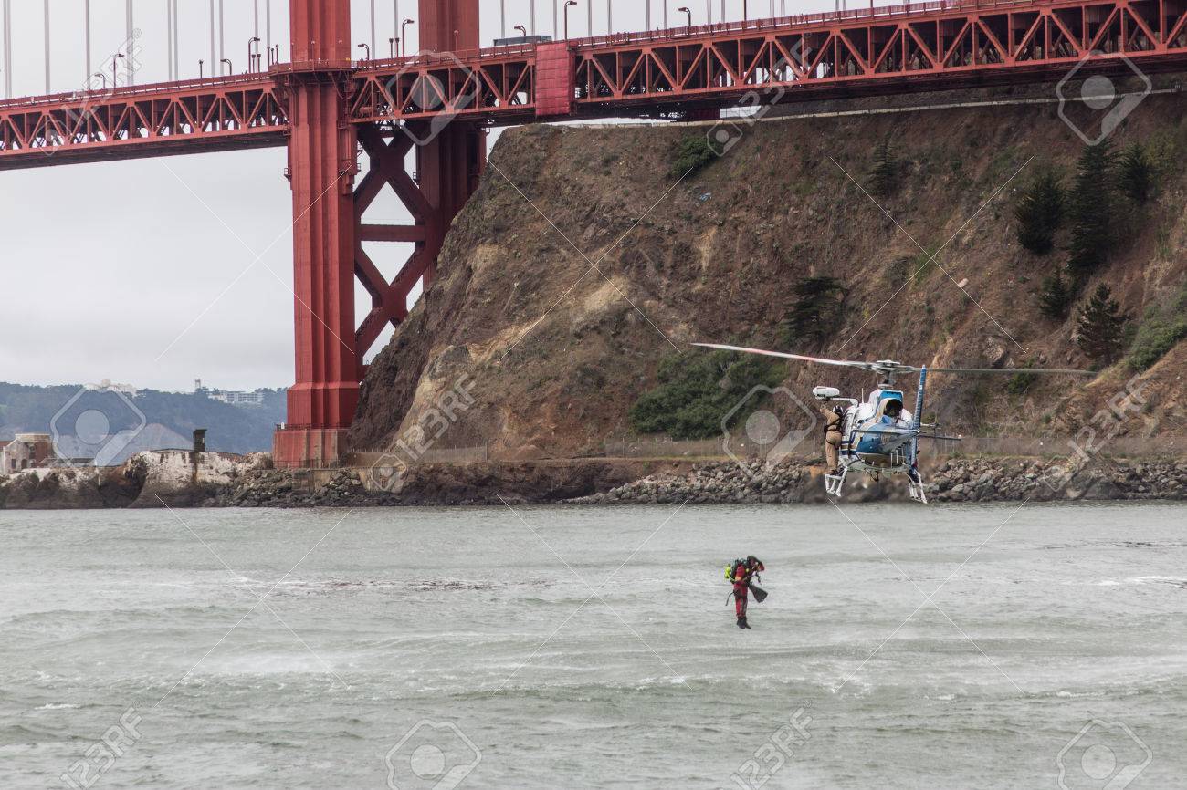 a chp helicopter flying under the golden gate bridge near the