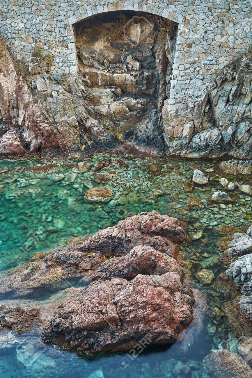 A Hole Into The Stone Wall At The Mediterranean Sea Coast That