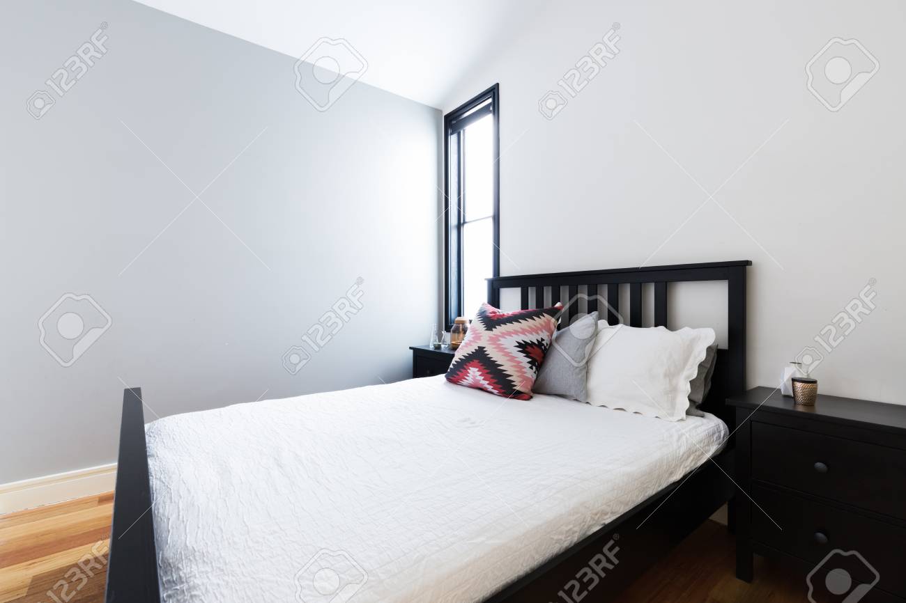 Clean Crisp Modern Bedroom With Painted Light Grey Feature Wall