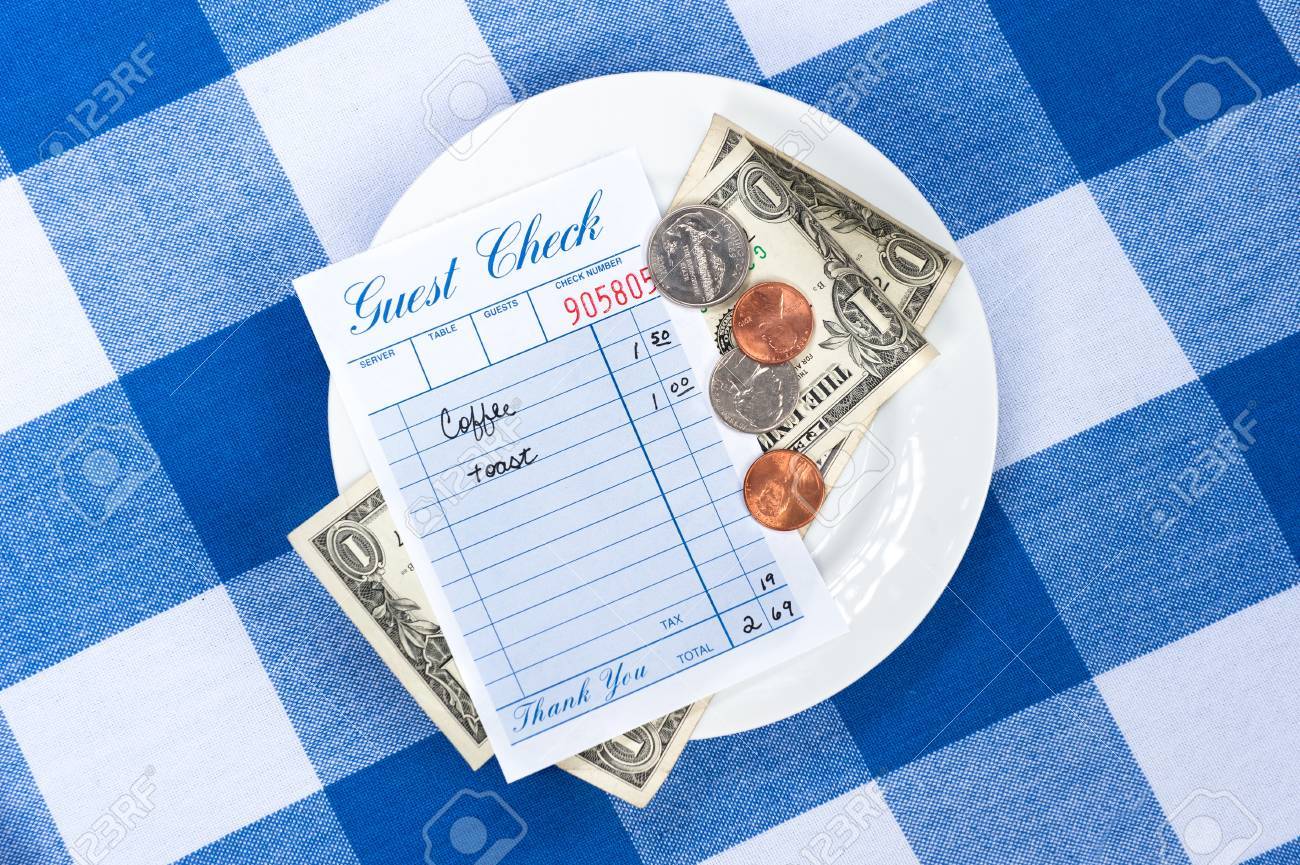 A dining check on a saucer with change from a meal payment. - 8622661 A dining check on a saucer with change from a meal payment. - 8622661