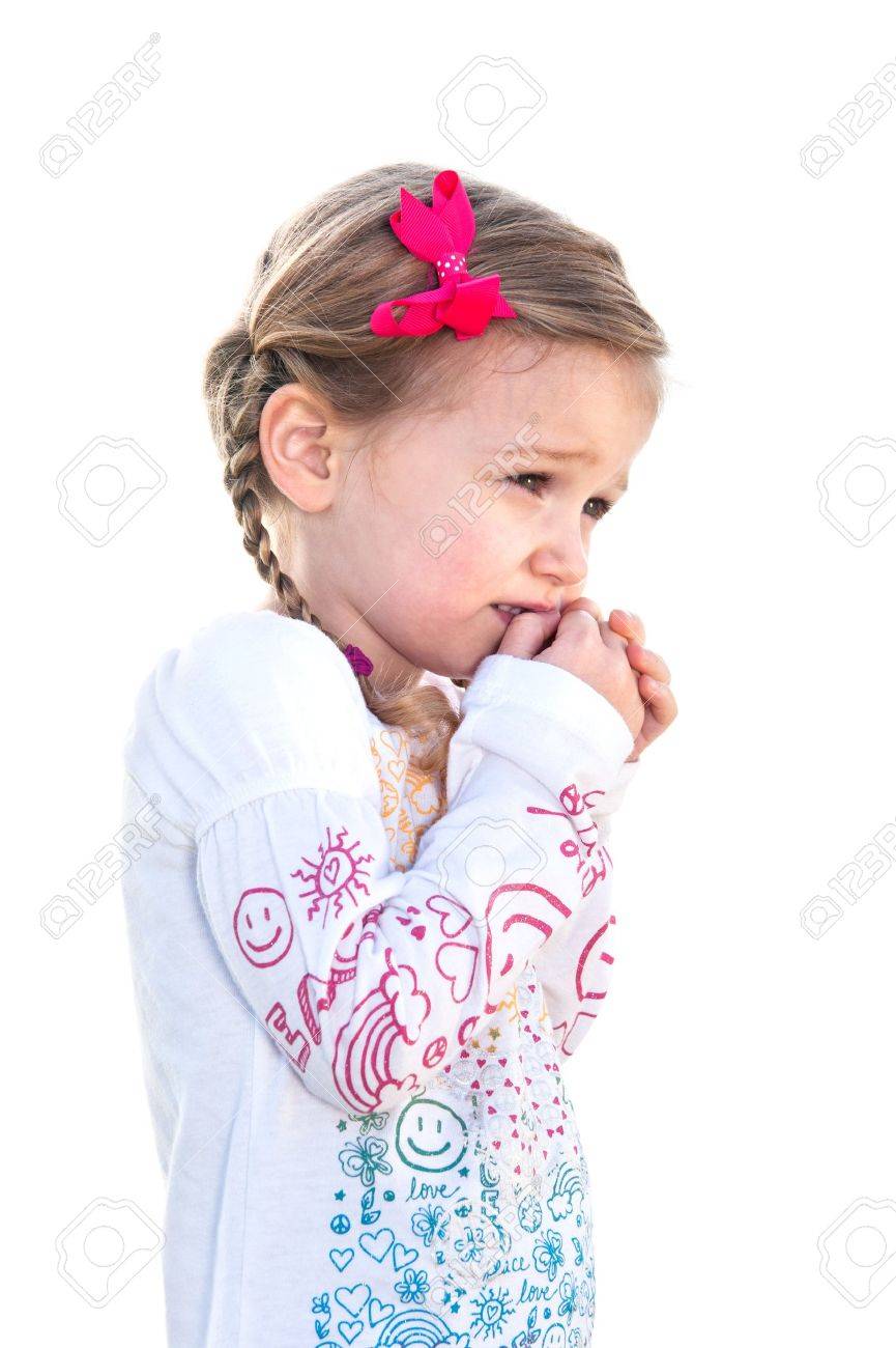 A beautiful little girl on a white background is frightened and holds her hand to her face. - 9139349 A beautiful little girl on a white background is frightened and holds her hand to her face. - 9139349