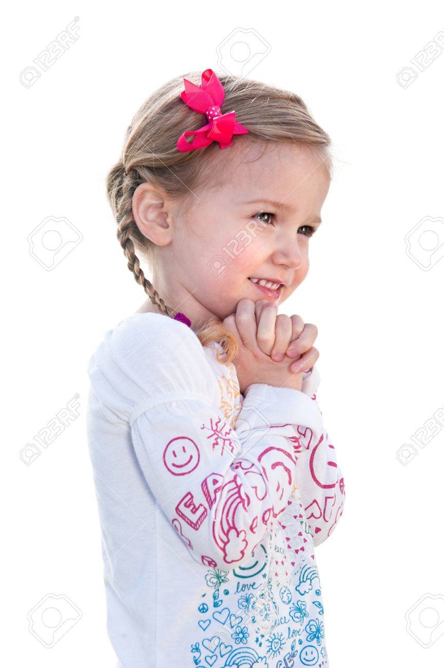 A beautiful little girl on a white background is happy and holds her hand to her face. - 9139346 A beautiful little girl on a white background is happy and holds her hand to her face. - 9139346
