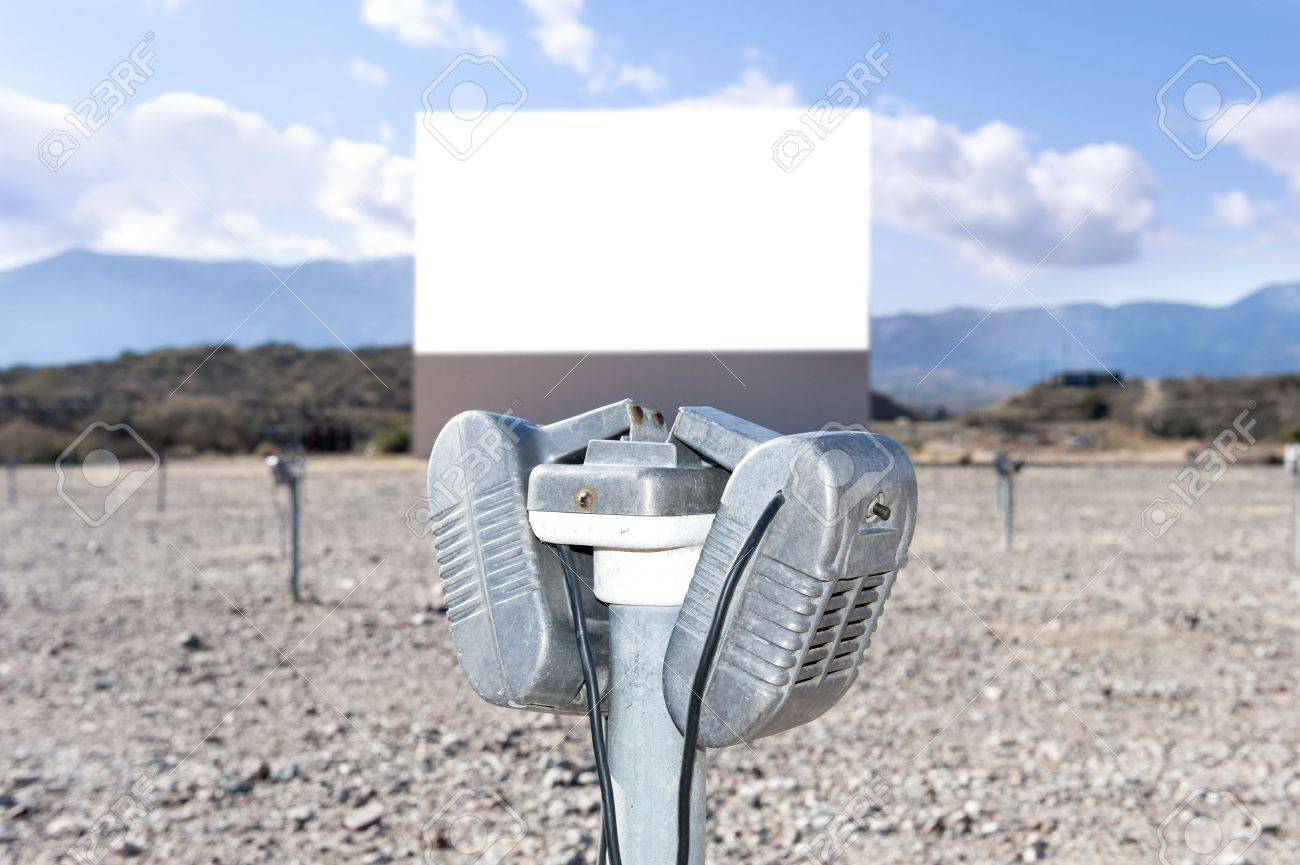 A vintage drive in theater with a close up of the window-mounted speaker. - 11840962 A vintage drive in theater with a close up of the window-mounted speaker. - 11840962