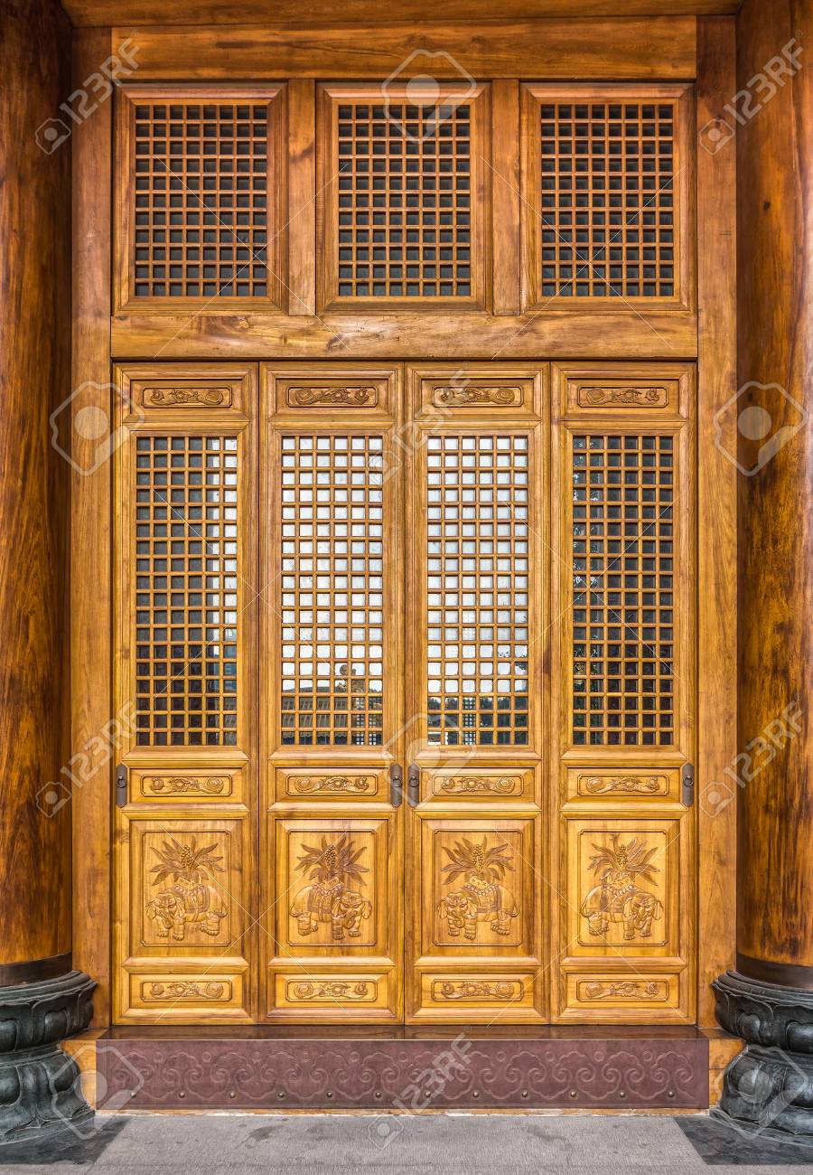 The Antique Chinese Wooden Carved Doors Of The Place Of Worship Stock Photo - The antique Chinese wooden carved doors of the place of worship in Jing - The Antique Chinese Wooden Carved Doors Of The Place Of Worship