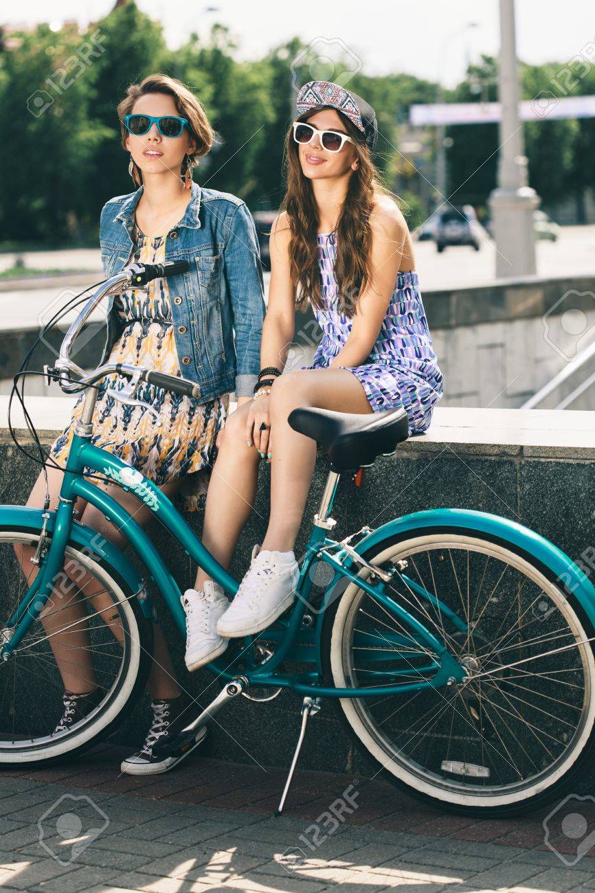 Mujer Joven Feliz En Gafas De Sol De Color Azul Con Una Tabla Skate En Sus Manos Durante El Día Fotos, Retratos, Imágenes Y Fotografía De Archivo Libres De Derecho. Image