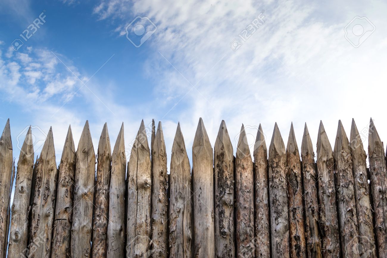 Wooden palisades form a defence barricade - 45967959 Wooden palisades form a defence barricade - 45967959