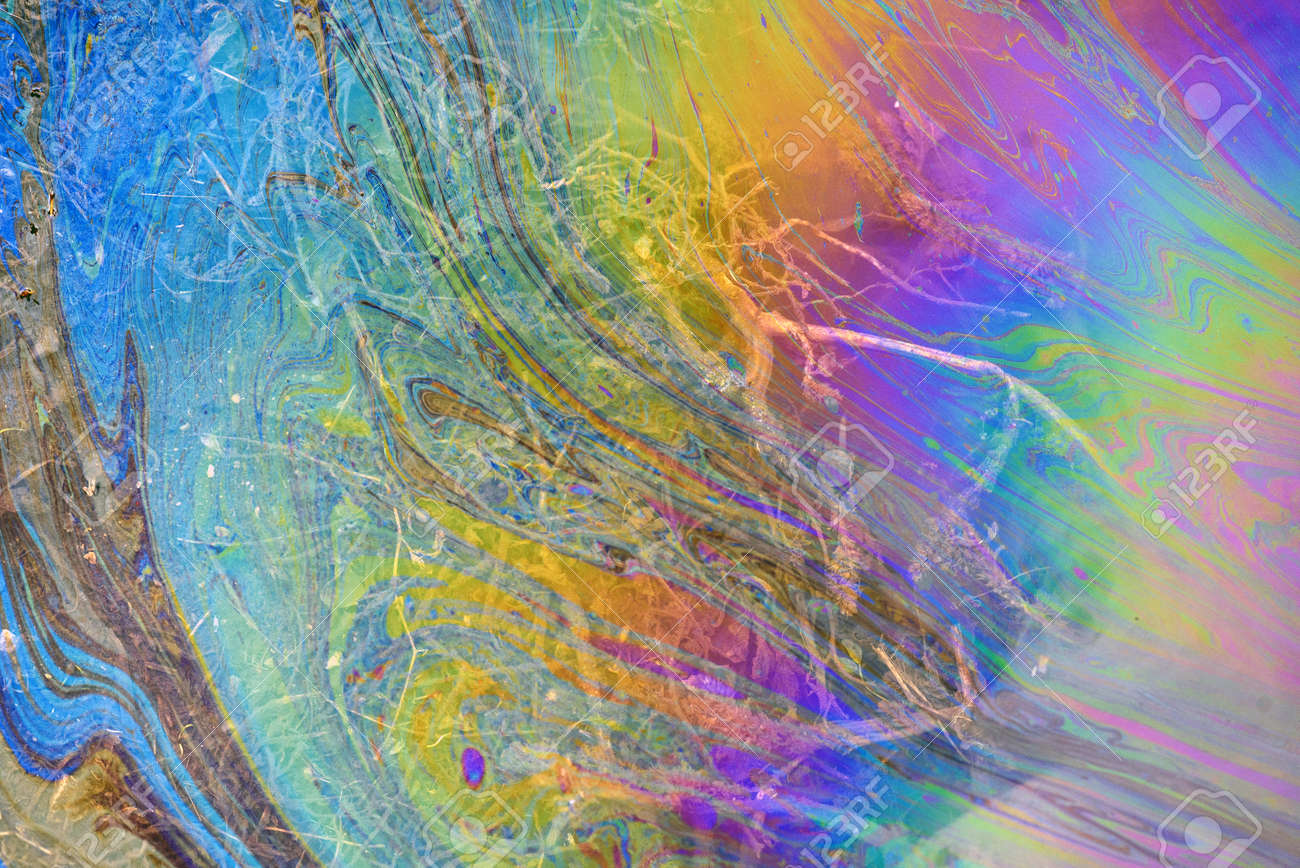 Toxic colours of oil and water in a chemical spill creating a psychedelic blur of rainbow colours. Copyspace area for environmental and pollution based themes and designs. - 155300752 Toxic colours of oil and water in a chemical spill creating a psychedelic blur of rainbow colours. Copyspace area for environmental and pollution based themes and designs. - 155300752