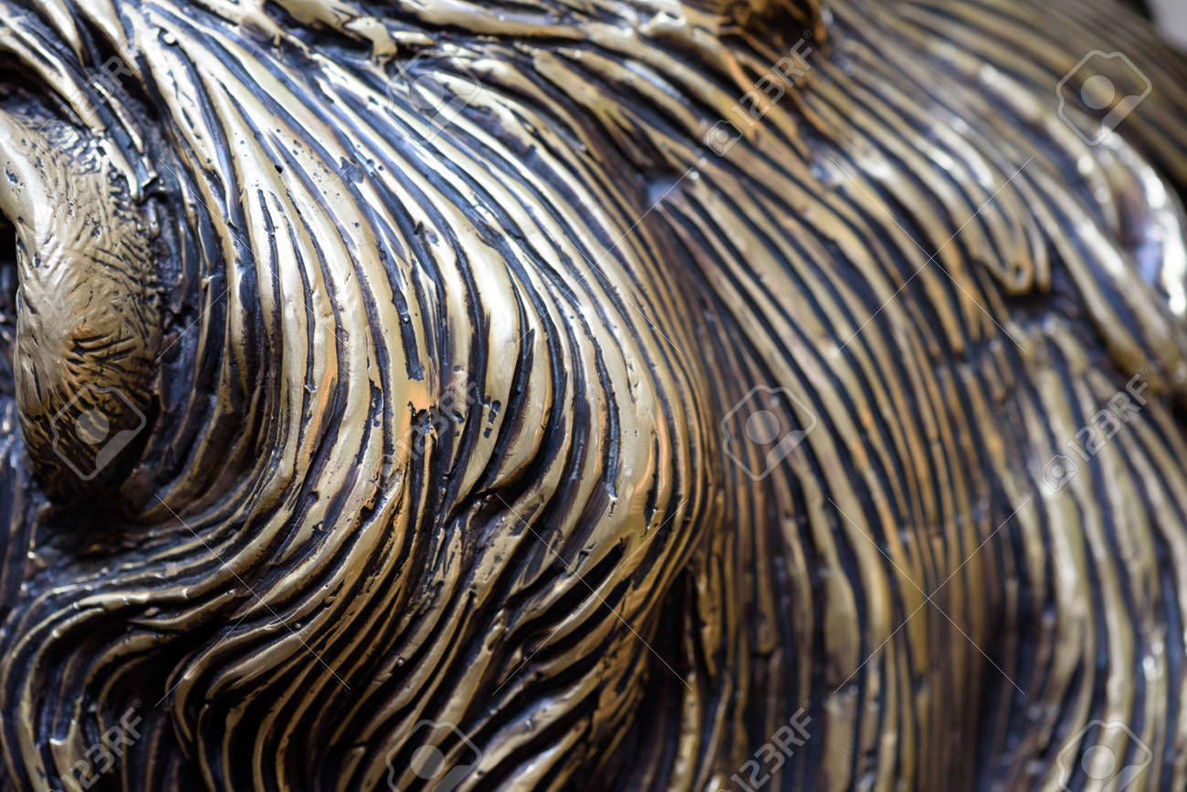 Bronze carving details in closeup macro view with attention to the strikes and curves of bronze and molten lead forming a unique pattern in metal - 155300754 Bronze carving details in closeup macro view with attention to the strikes and curves of bronze and molten lead forming a unique pattern in metal - 155300754