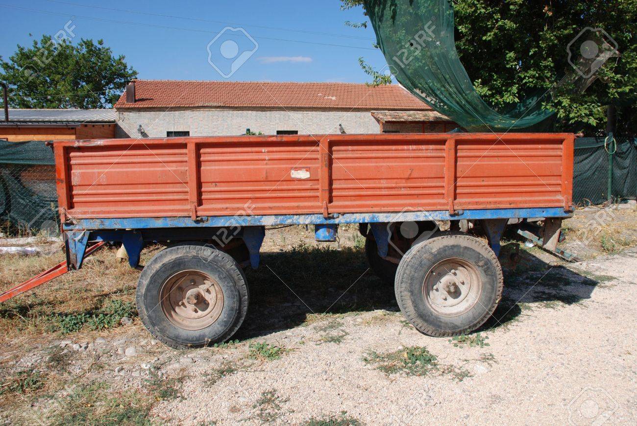 An Old Red Trailer Used On A Farm Stock Photo An Old Red Trailer Used On A Farm Stock Photo