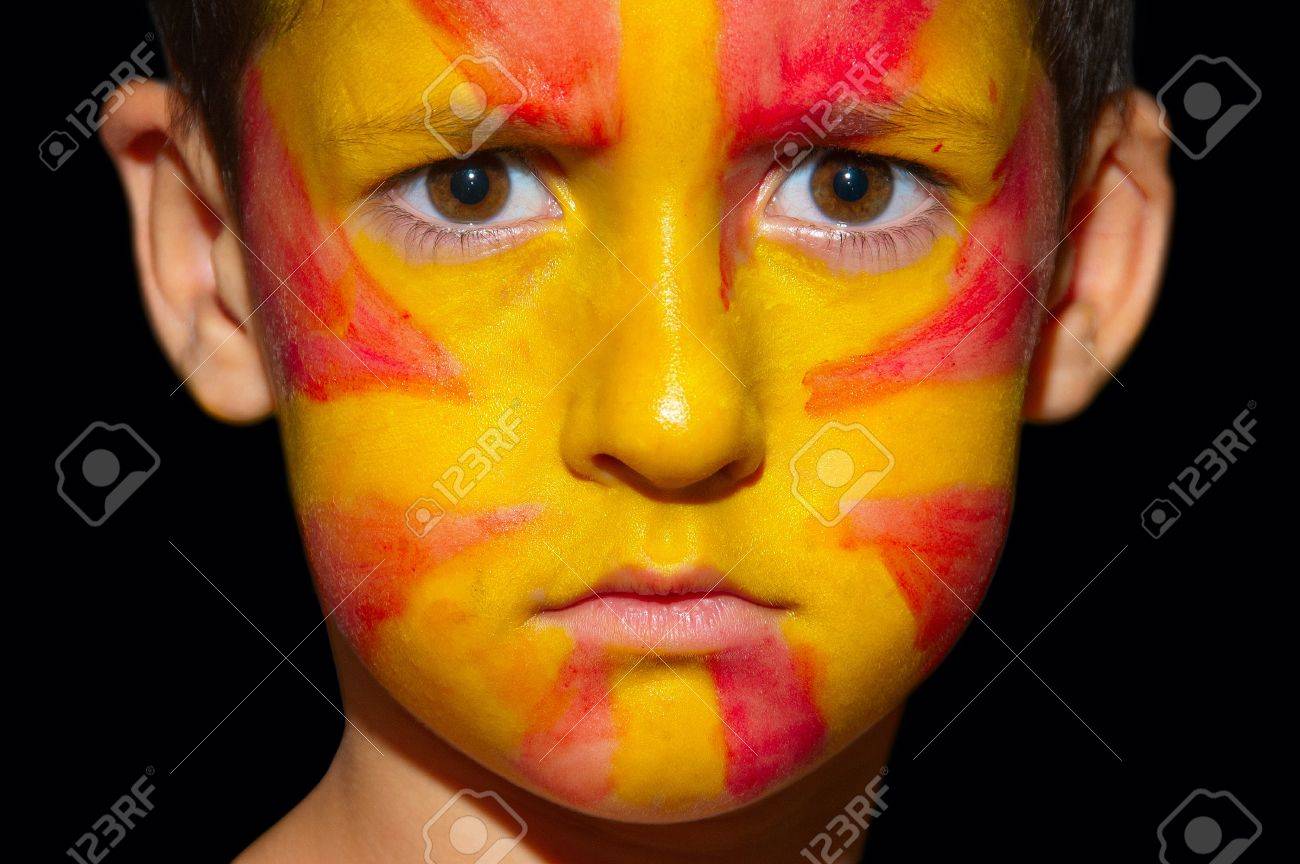 A 暗い背景の上の少年の顔に マケドニアの旗のクローズ アップ の写真素材 画像素材 Image