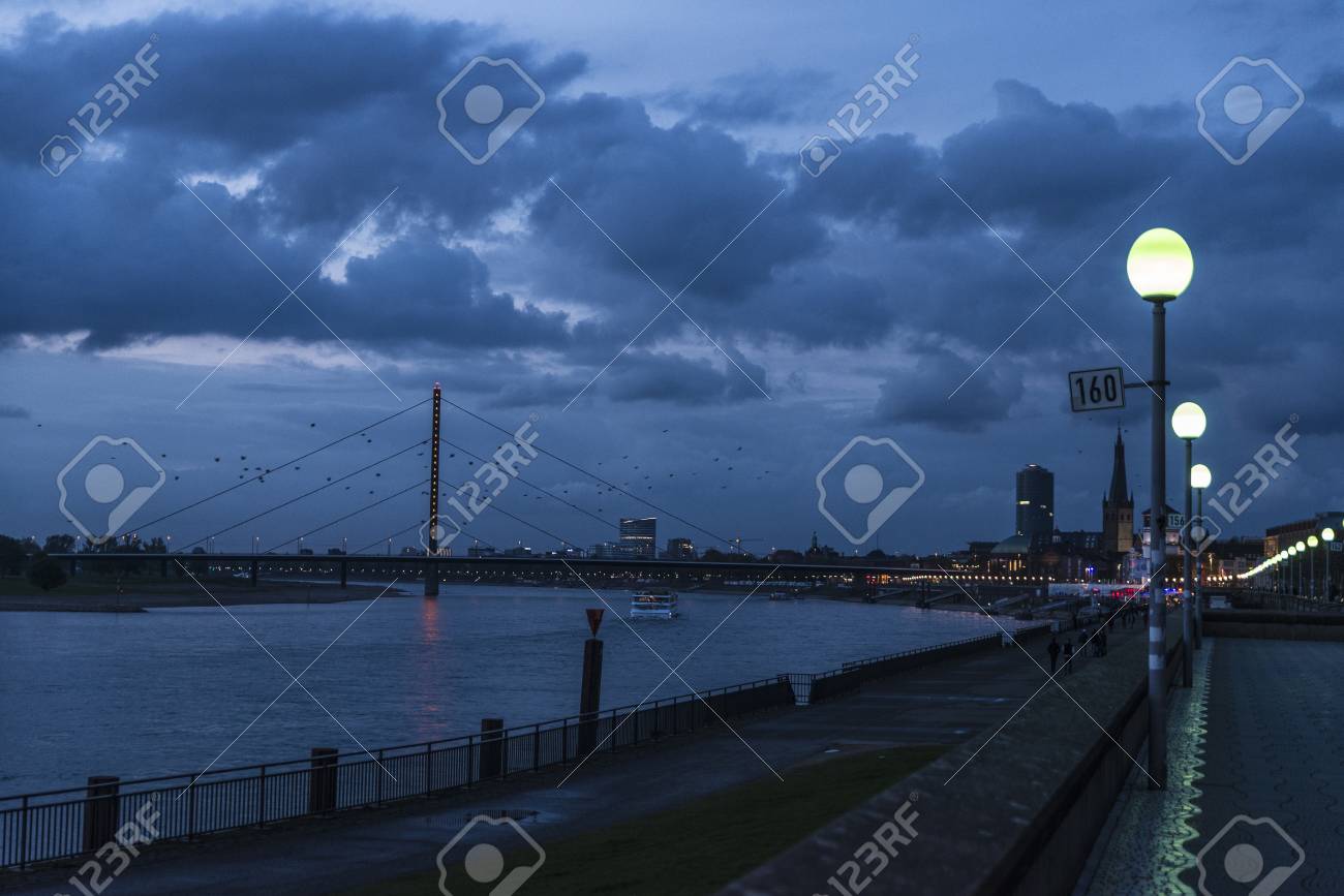 View of the promenade and the Oberkassel bridge at night in Dusseldorf, Germany - 85882600 View of the promenade and the Oberkassel bridge at night in Dusseldorf, Germany - 85882600