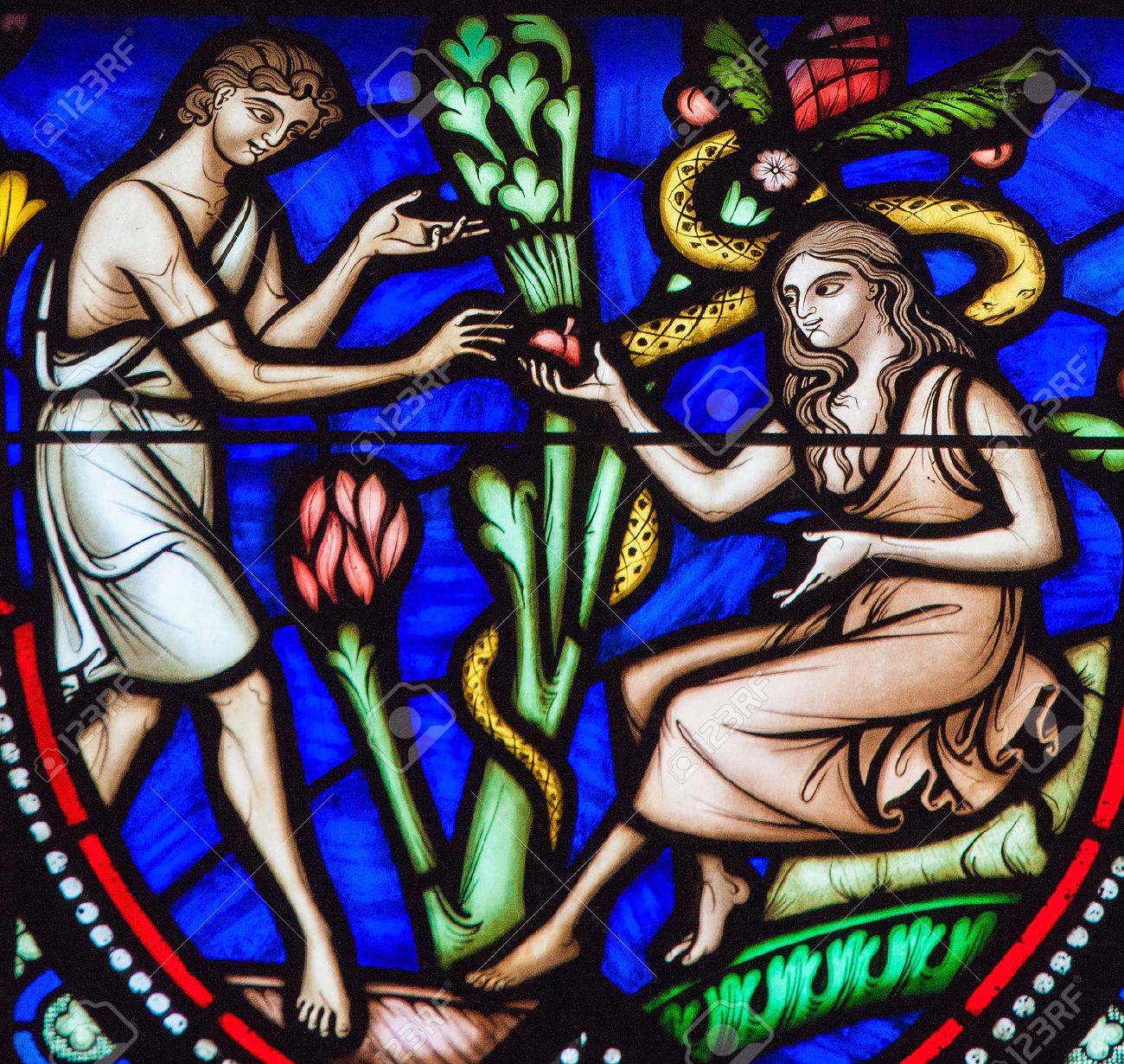 BRUSSELS, BELGIUM - JULY 26, 2012: Adam and Eve eating the Forbidden Fruit in the Garden of Eden on a stained glass window in the cathedral of Brussels. - 54680925 BRUSSELS, BELGIUM - JULY 26, 2012: Adam and Eve eating the Forbidden Fruit in the Garden of Eden on a stained glass window in the cathedral of Brussels. - 54680925
