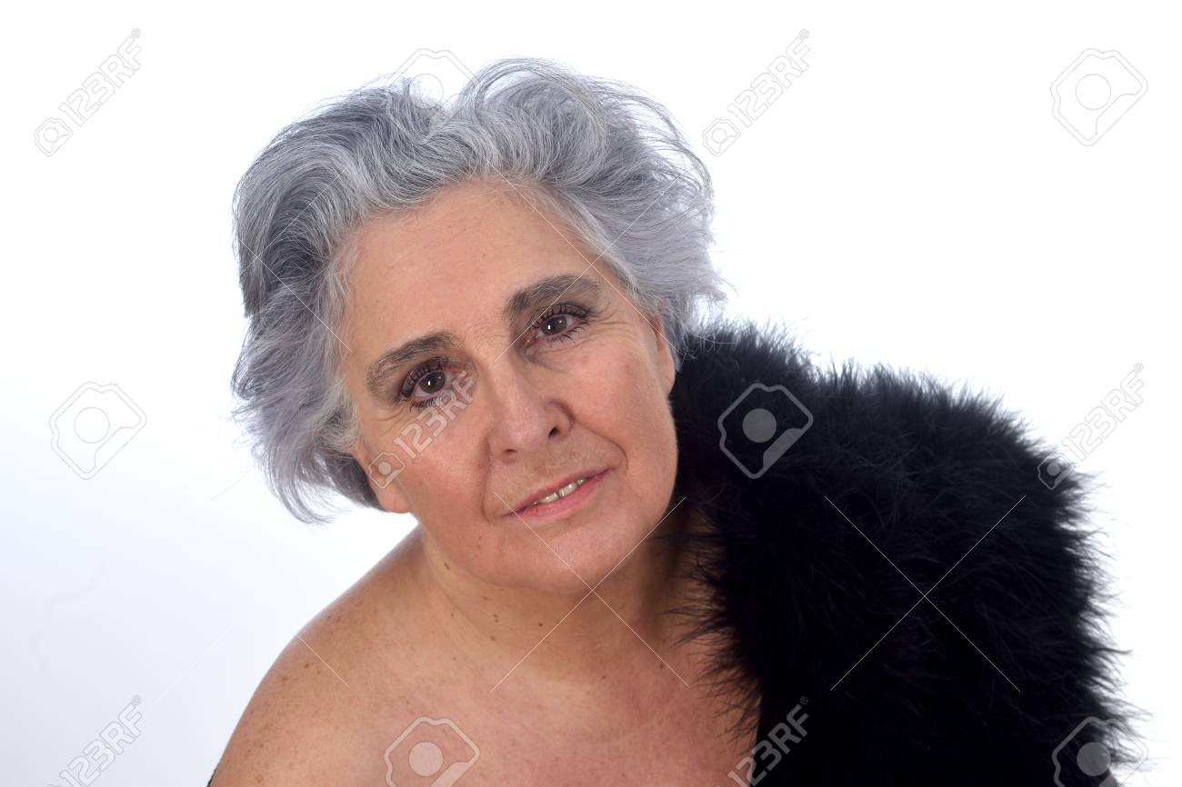 An Older Woman With A Sexy Posed On White Background Stock Photo