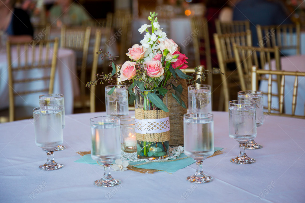 DIY Wedding Decor Table Centerpieces With Wine Bottles Wrapped In Burlap  Twine And Rose Flowers. Stock Photo, Picture and Royalty Free Image. Image  28003096., image size:1300x867
