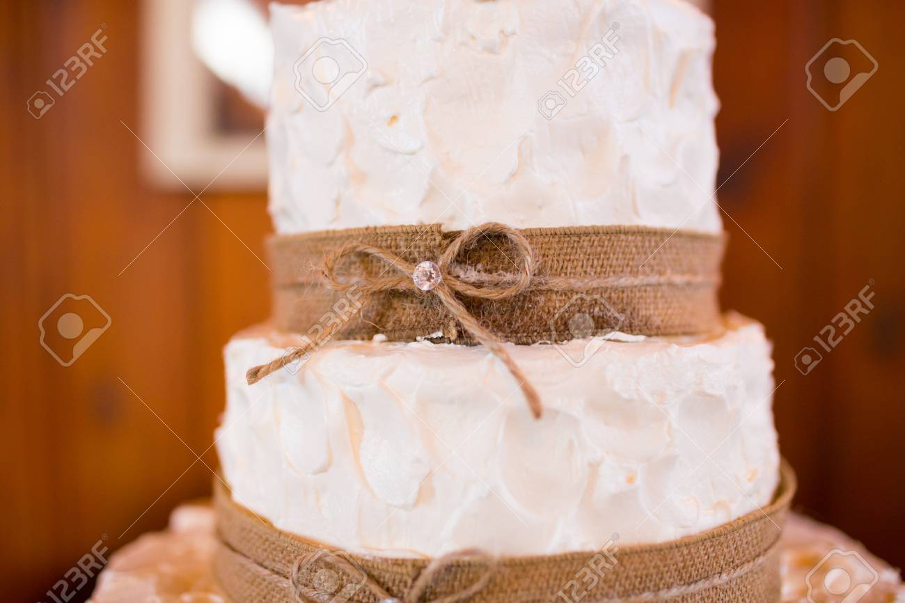 Wedding Cake At A Reception Party In All White With Burlap And