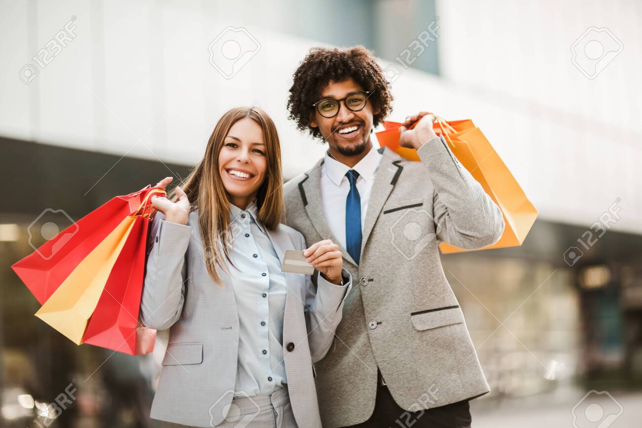 Couple in shopping. Happy couple with shopping bags and credit card enjoying in shopping. - 153525835 Couple in shopping. Happy couple with shopping bags and credit card enjoying in shopping. - 153525835
