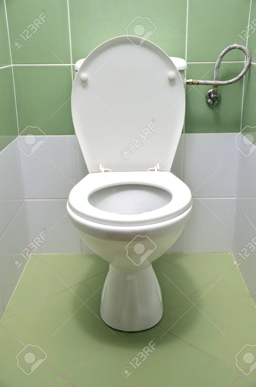 Flush Toilet With White And Green Tiles In Background, Front View Stock  Photo, Picture and Royalty Free Image. Image 55804879., image size:861x1300