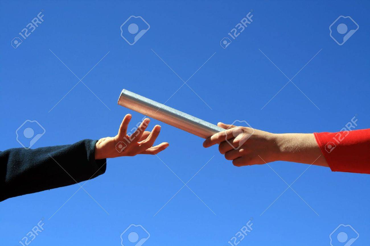 Hands Passing The Batton Against Blue Sky Stock Photo Picture And Royalty Free Image Image