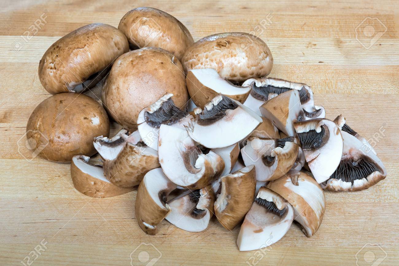 Baby Portobello Mushrooms Whole And Sliced On Wood Cutting Board Closeup Macro Stock Photo Picture And Royalty Free Image Image 100638759