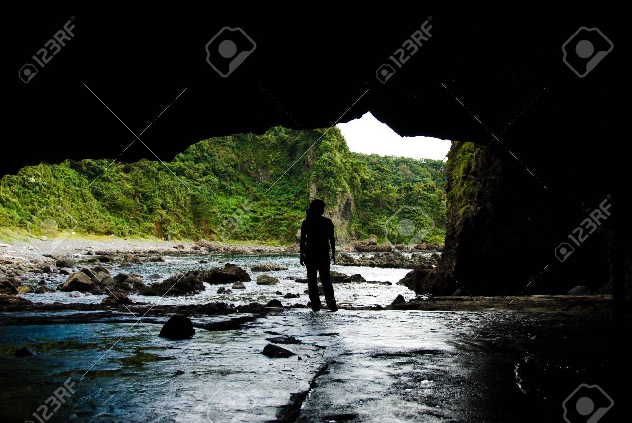 海の近くの洞窟の入り口に立つ の写真素材 画像素材 Image