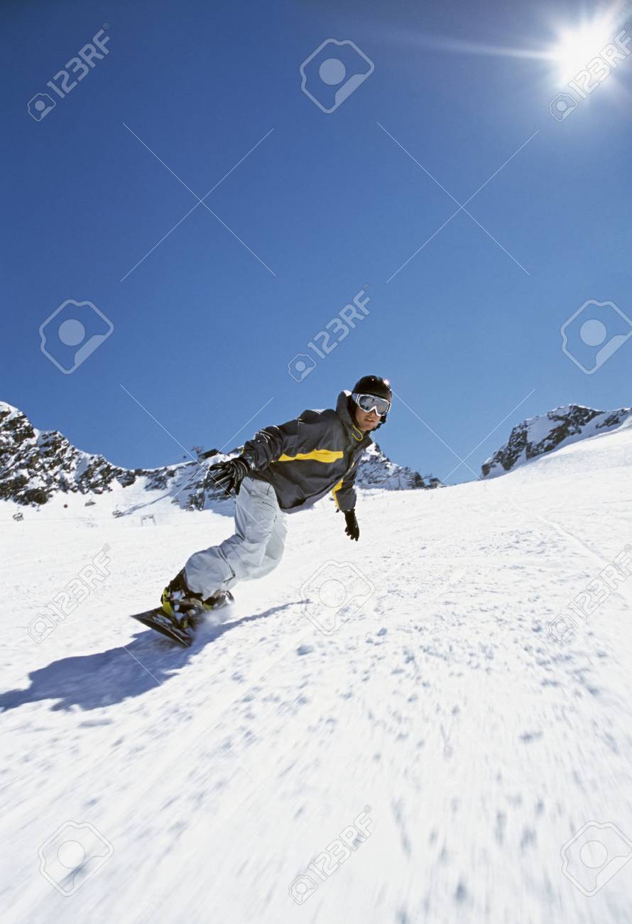 person snowboarding down mountain
