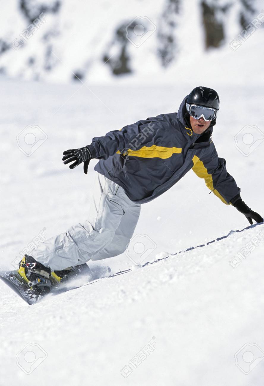 person snowboarding down mountain