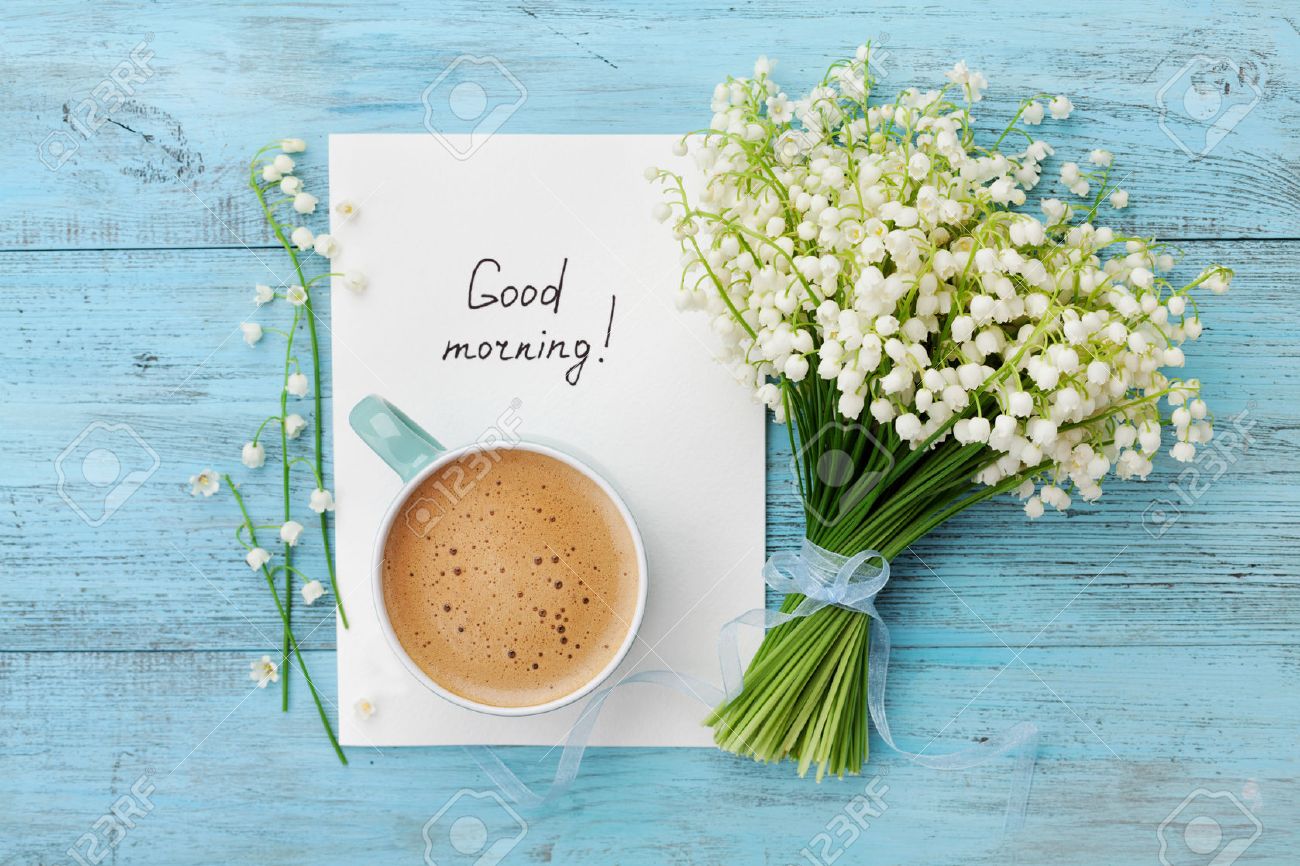 Coffee mug with bouquet of flowers lily of the valley and notes good morning on turquoise rustic table from above, beautiful breakfast, vintage card, top view, flat lay - 58821365 Coffee mug with bouquet of flowers lily of the valley and notes good morning on turquoise rustic table from above, beautiful breakfast, vintage card, top view, flat lay - 58821365