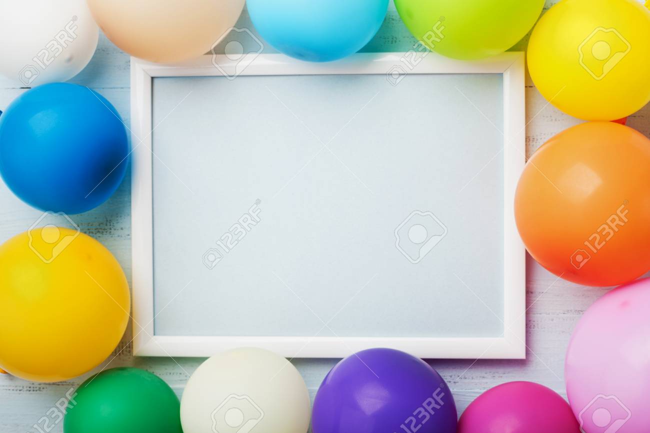 Download Colorful Balloons And White Frame On Blue Wooden Table Top View Stock Photo Picture And Royalty Free Image Image 83873338