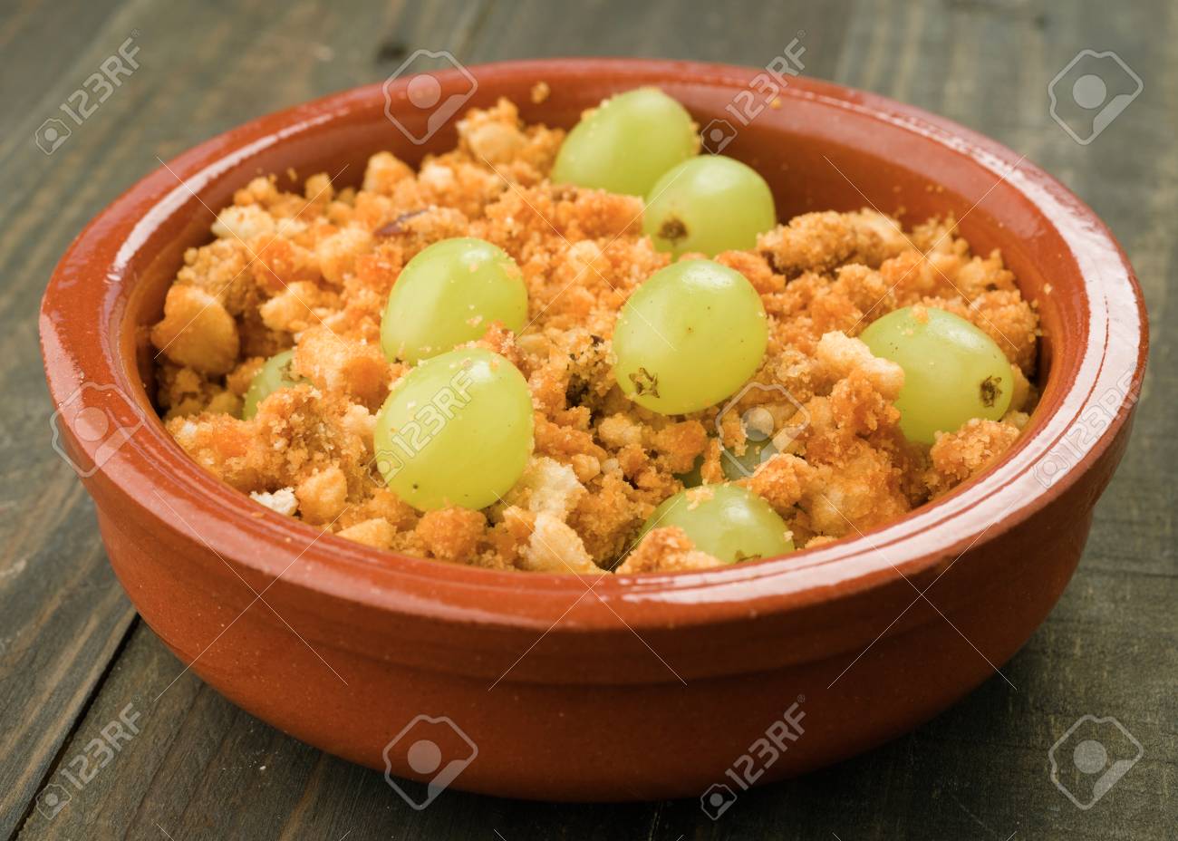 shepherd crumbs with fresh grapes typical spanish snack stock photo