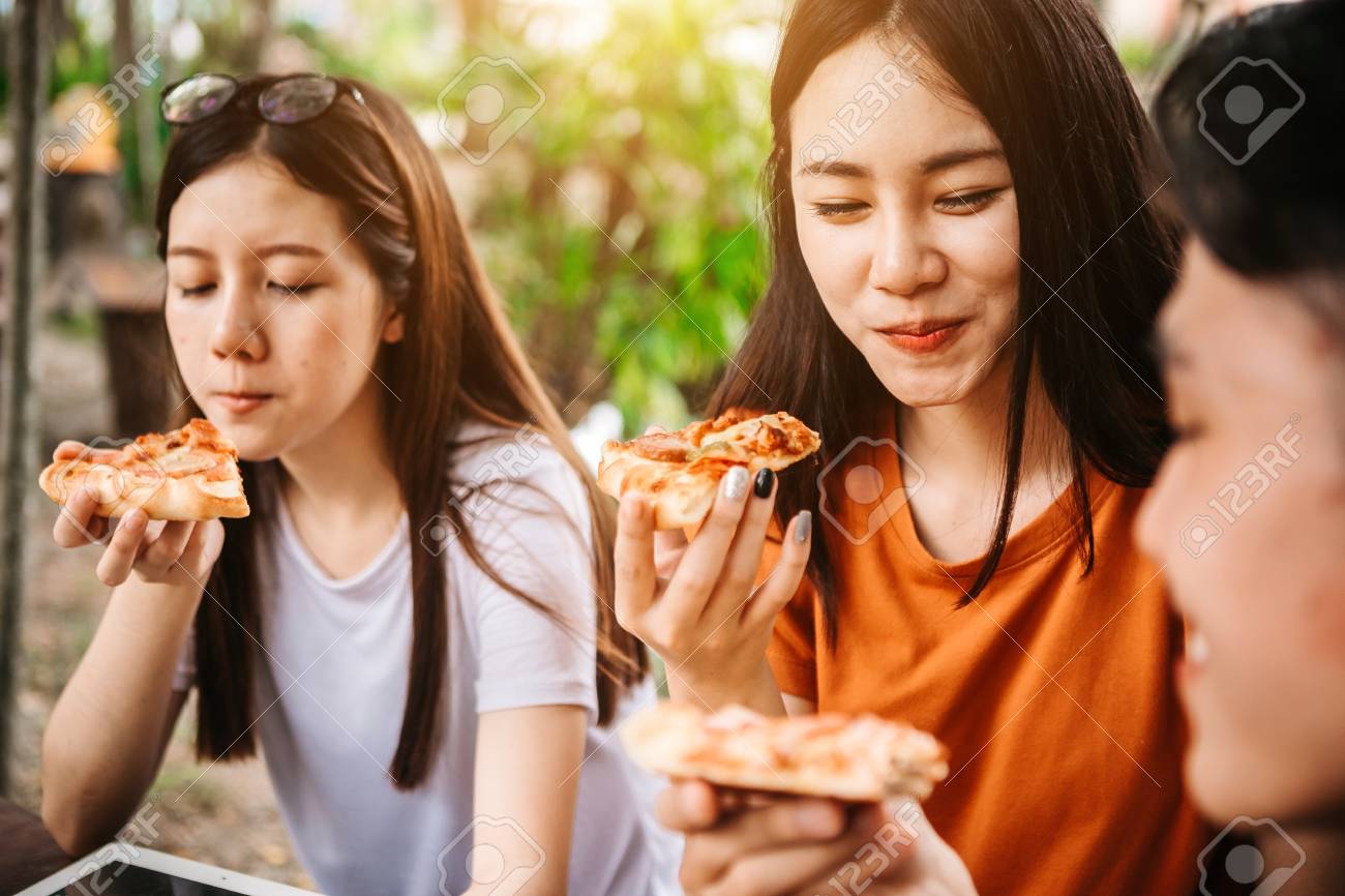 Asian students eating eating the pizza together in breaking time early next study class having fun and enjoy party, Italian food slice with cheese delicious at university outdoor. - 93467278 Asian students eating eating the pizza together in breaking time early next study class having fun and enjoy party, Italian food slice with cheese delicious at university outdoor. - 93467278