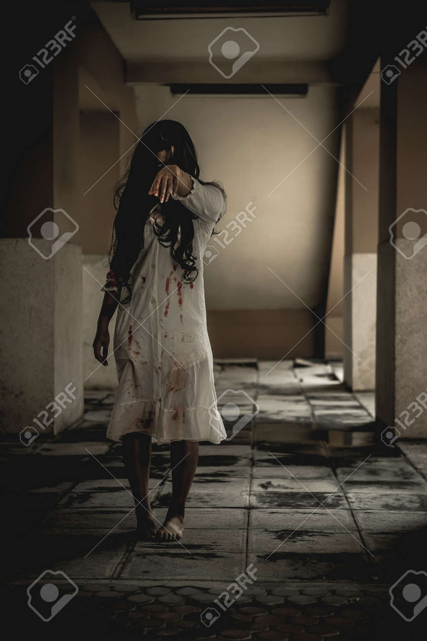Woman in ghost or zombie on halloween festival at dark place, holding knife and wants to stab you. Horror or halloween festival concept. - 157438637 Woman in ghost or zombie on halloween festival at dark place, holding knife and wants to stab you. Horror or halloween festival concept. - 157438637