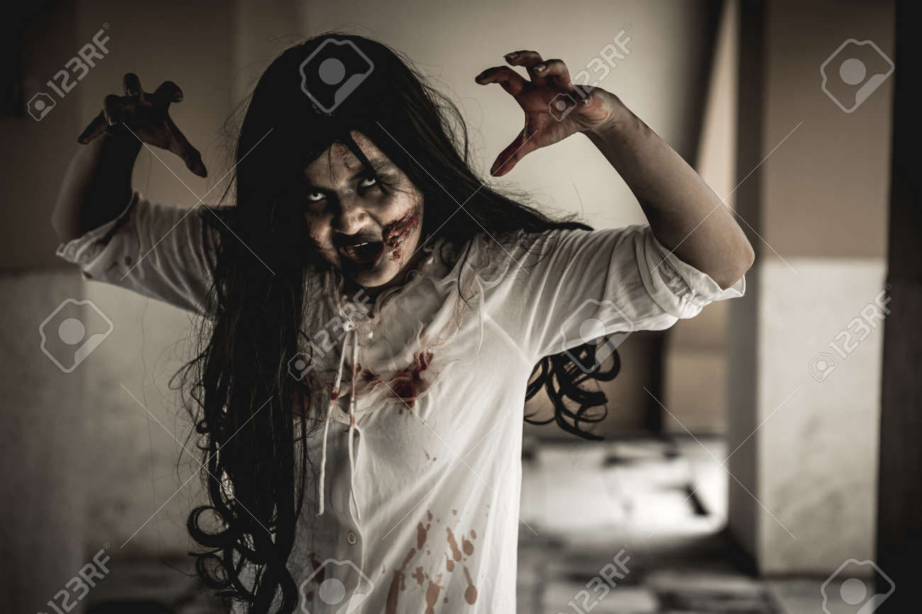Woman in ghost or zombie on halloween festival at dark place, holding knife and wants to stab you. Horror or halloween festival concept. - 158692220 Woman in ghost or zombie on halloween festival at dark place, holding knife and wants to stab you. Horror or halloween festival concept. - 158692220