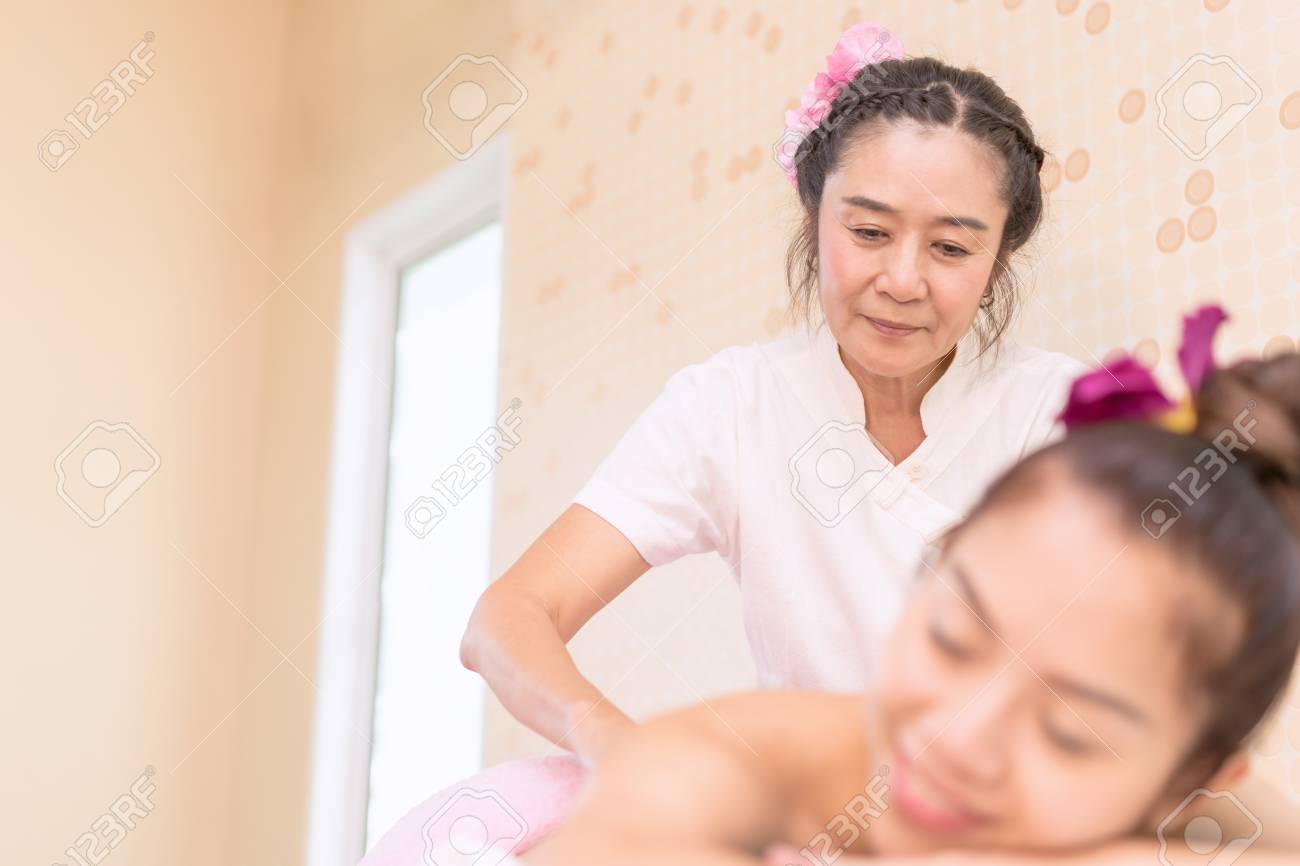 spa therapist is giving oil massage to a woman in thai spa stock spa therapist