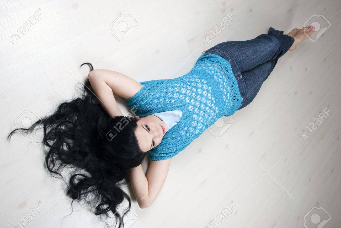 Top View Of Beautiful Brunette With Long Hair Lying Down With