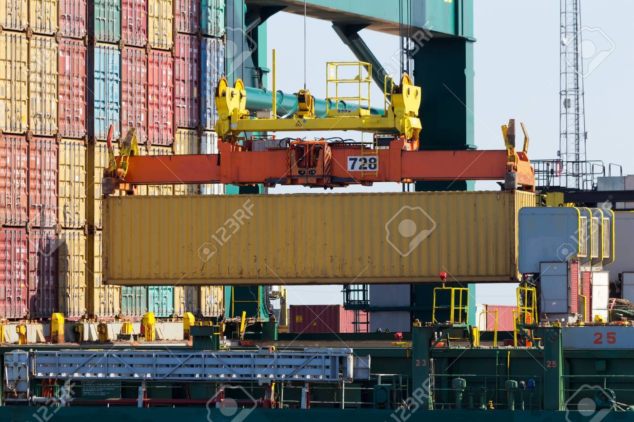 Harbor Crane Lifting A Sea Container Into A Cargo Ship Stock Photo, Picture And Royalty Free Image. Image 27576849.