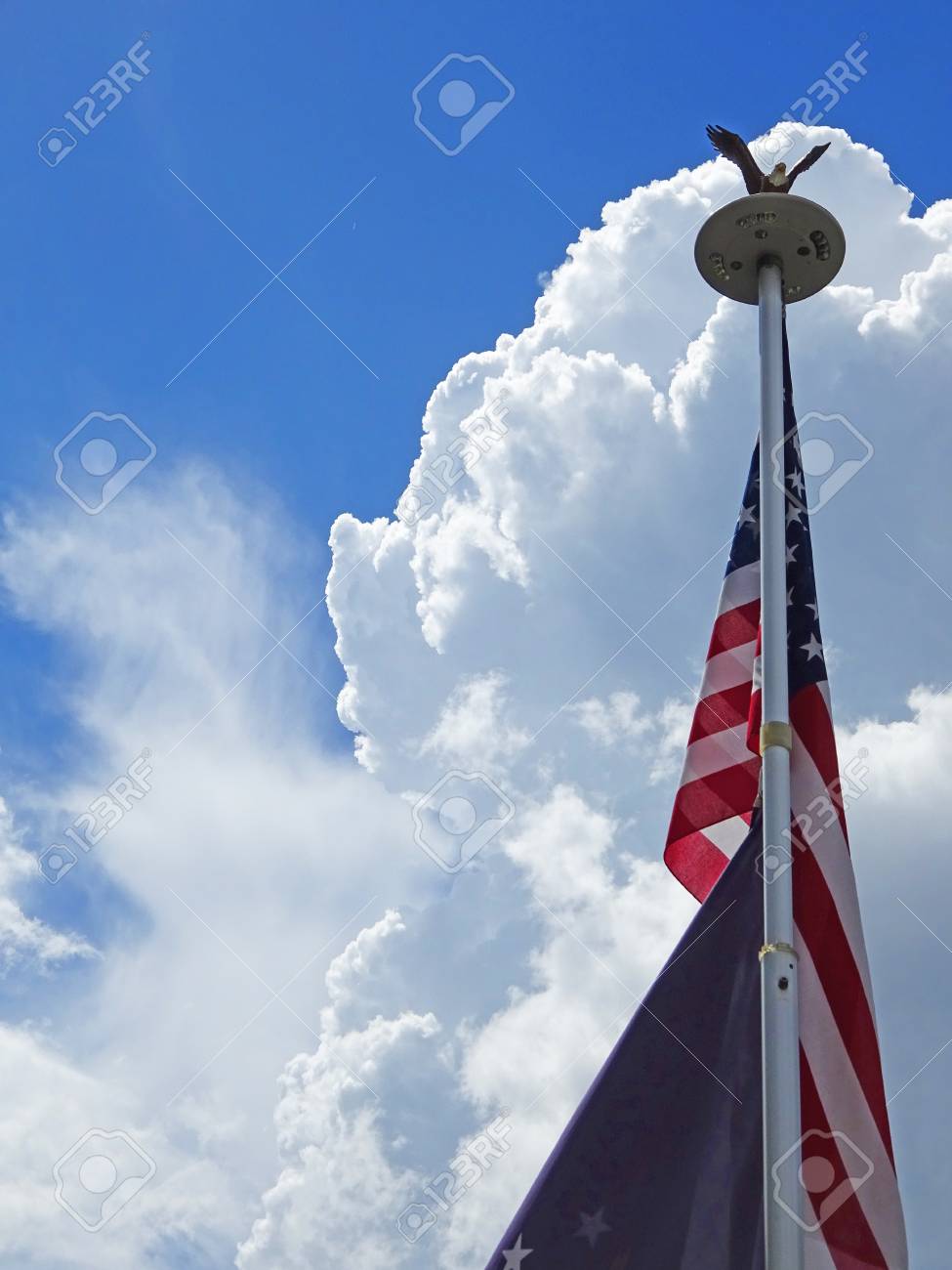 American Flag On Bald Eagle Flag Pole With White Clouds Stock Photo,  Picture and Royalty Free Image. Image 85249761., image size:975x1300
