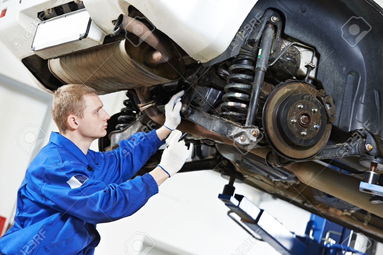 auto mechanic at car suspension repair work stock photo picture and motor mechanic