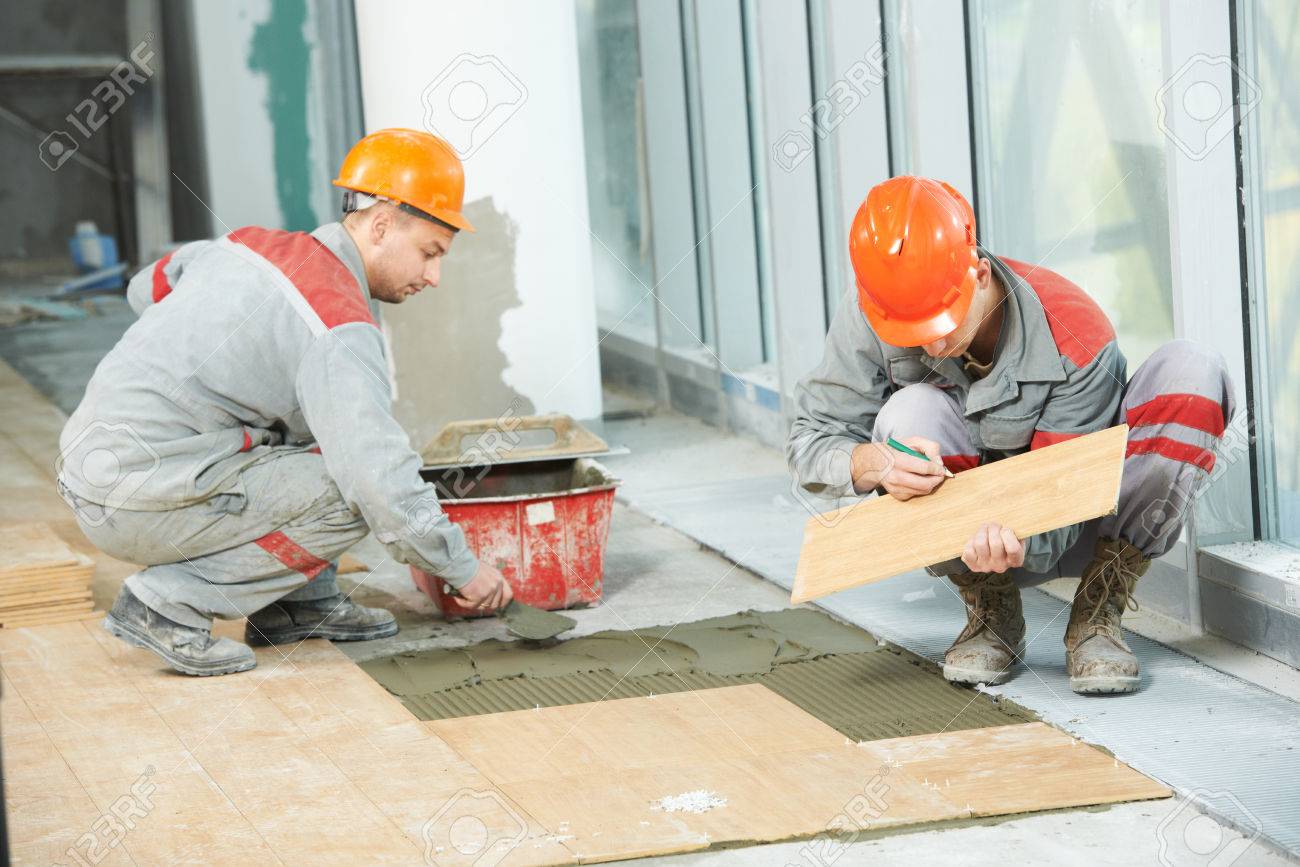 Floor Tile Repair tile repair Stock Photo Two Industrial Tiler Builder Worker Installing Floor Tile At Repair Renovation Work Floor Tile Repair tile cracks Stock Photo Two Industrial Tiler Builder Worker Installing Floor Tile At Repair Renovation Work