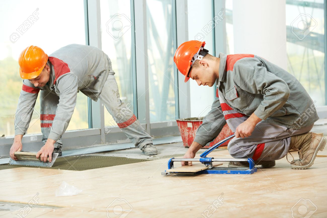 Floor Tile Repair stickit tile repair kit for loose tiles Stock Photo Two Industrial Tiler Builder Worker Installing Floor Tile At Repair Renovation Work Floor Tile Repair wood floor repair kit uk gurus floor Stock Photo Two Industrial Tiler Builder Worker Installing Floor Tile At Repair Renovation Work
