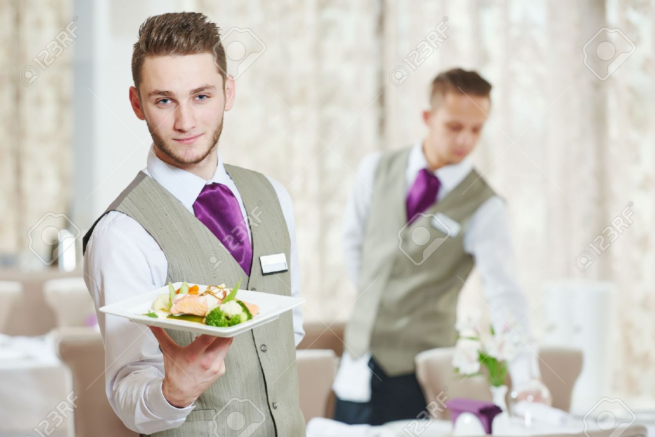waiter occupation young man with food on dishes servicing in