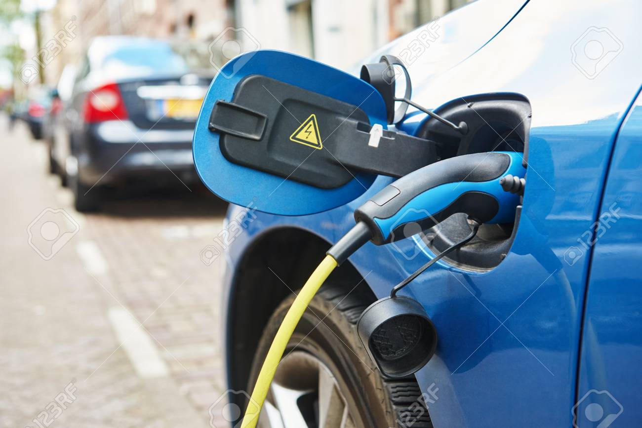 alternative eco energy fuel. Close up of the power supply plugged into an electric car during charging in Amsterdam - 50038053 alternative eco energy fuel. Close up of the power supply plugged into an electric car during charging in Amsterdam - 50038053