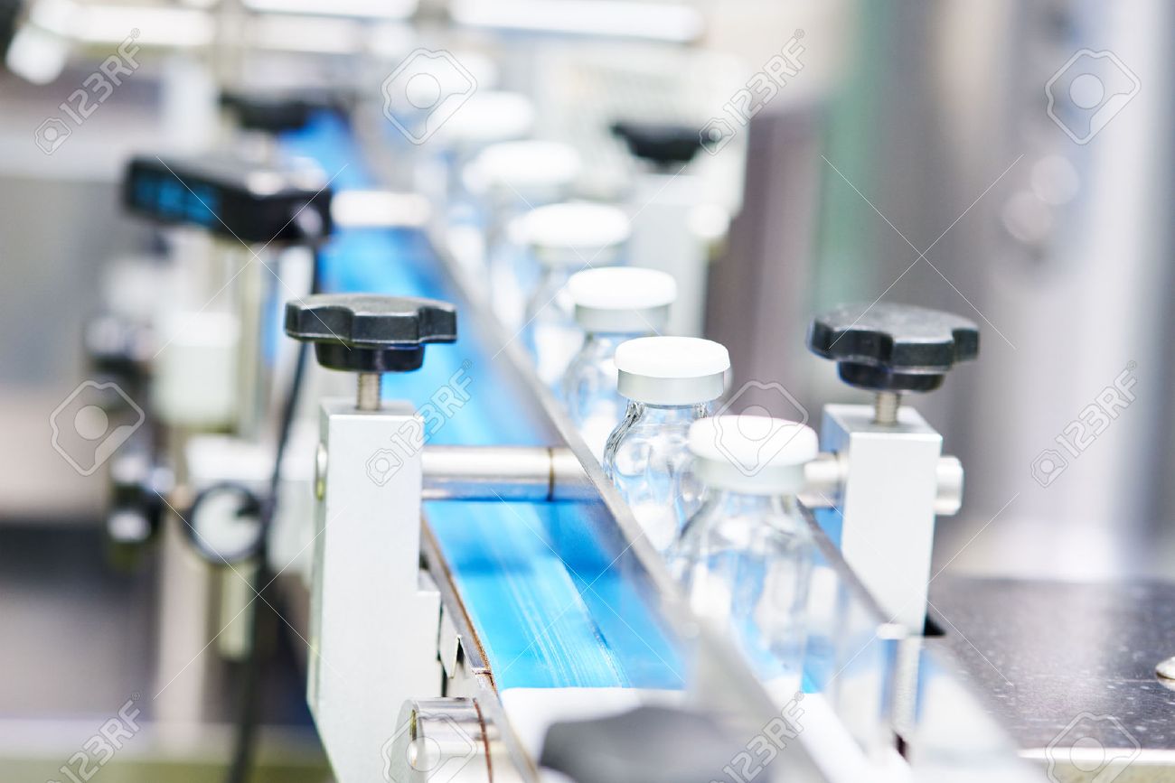 pharmaceutical industry. Production line machine conveyor with glass bottles ampoules at factory, Shallow DOF - 50038101 pharmaceutical industry. Production line machine conveyor with glass bottles ampoules at factory, Shallow DOF - 50038101