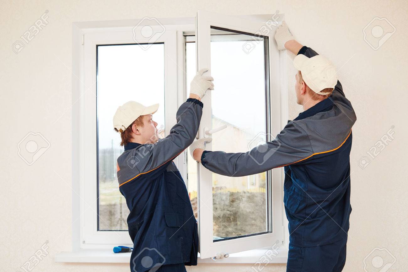 construction workers glaziers installing glass window indoor glass glaziers