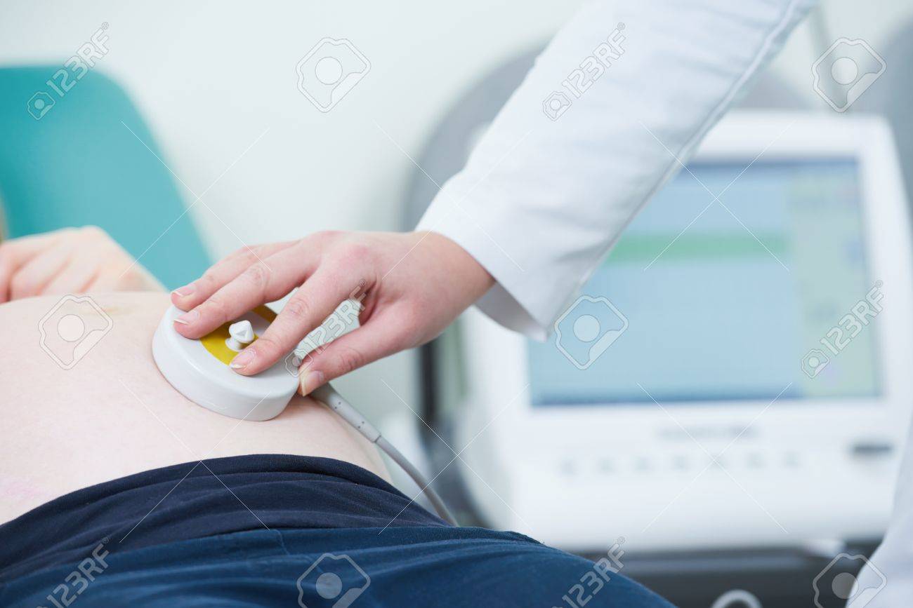 Pregnancy care. cardiotocography fetal heartbeat examination - 77470562 Pregnancy care. cardiotocography fetal heartbeat examination - 77470562