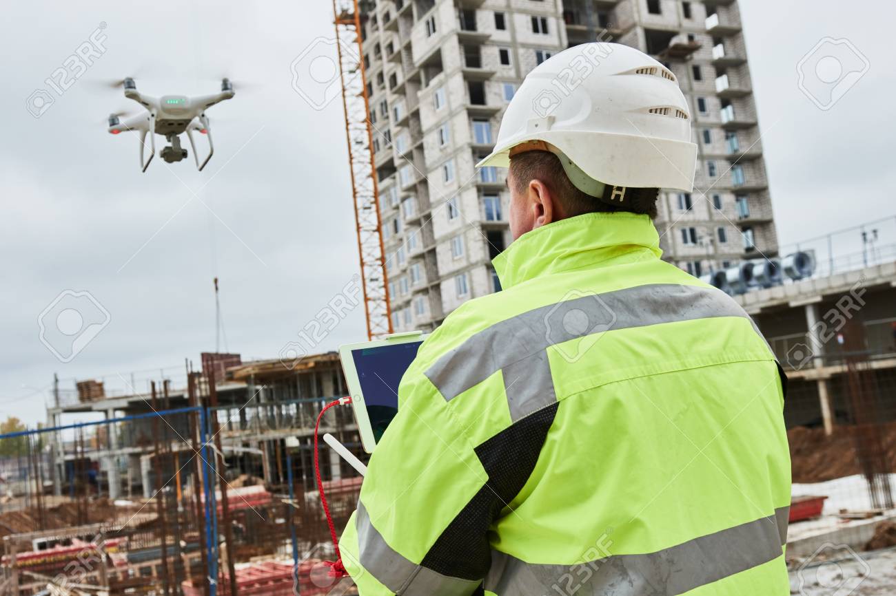 Drone operated by construction worker on building site - 88540595 Drone operated by construction worker on building site - 88540595
