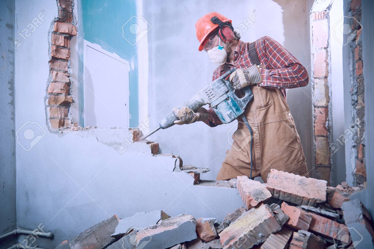 worker with demolition hammer breaking interior wall - 92106897 worker with demolition hammer breaking interior wall - 92106897
