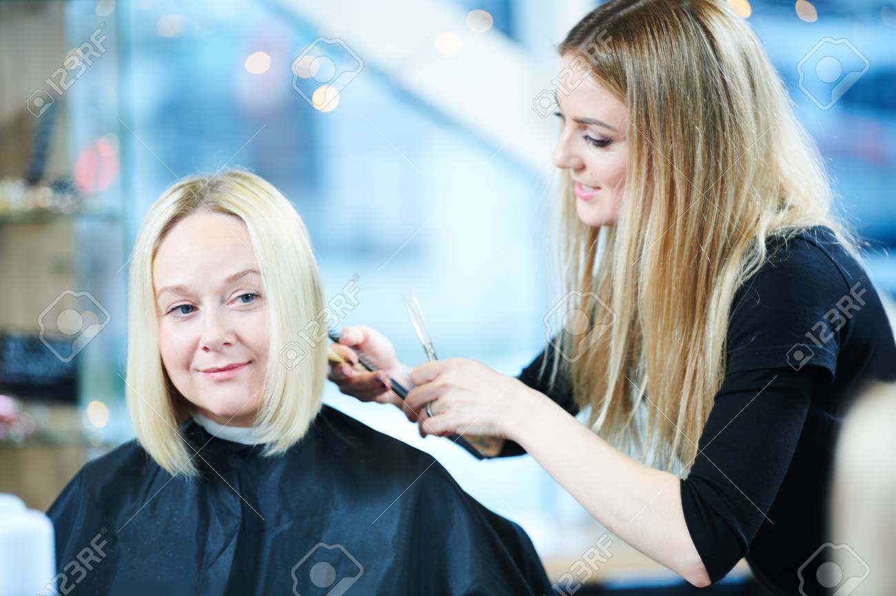 Barber Or Stylist At Work Hairdresser Cutting Woman Hair Stock